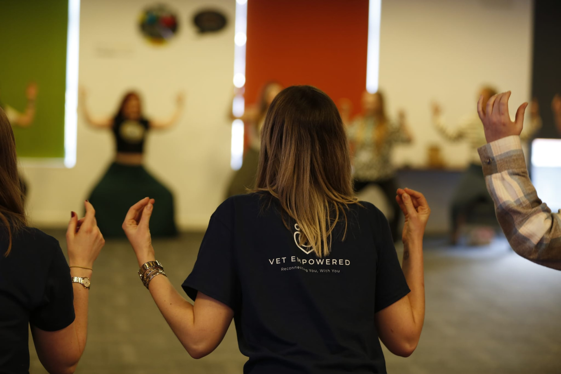 Veterinary professionals standing together in a breathing and movement exercise at a Vet Empowered event.